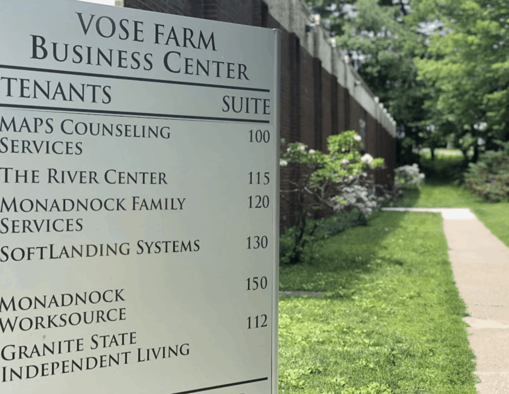 vose farm business center sign in foreground with path to enter the building behind